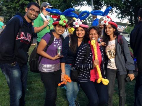 International students with balloon animals on their heads